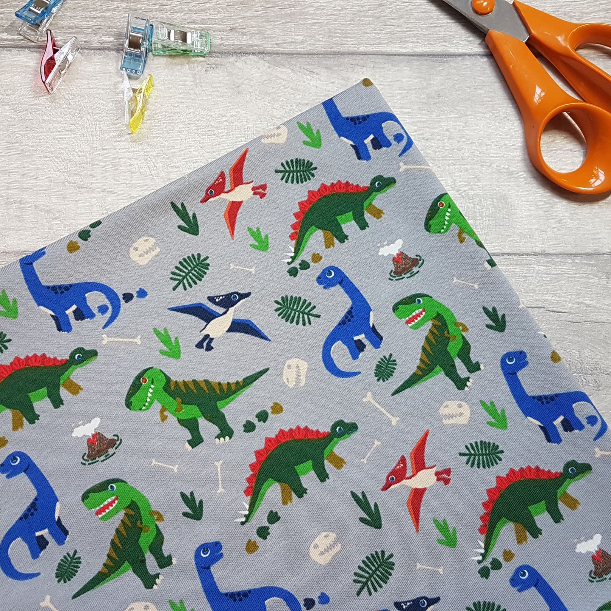 Dinosaur Jersey Fabric 95% cotton 5% spandex metre material knit t-rex navy bg