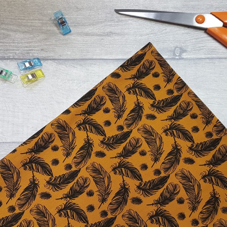 Whimsical Feathers Ochre Cotton Jersey Knit Fabric