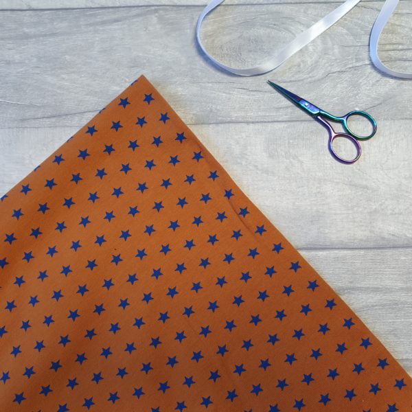 Little Stars Blue On Burnt Orange Cotton Elastane Jersey Knit Fabric