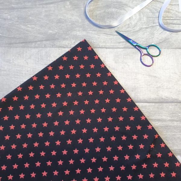 Little Stars Coral on Black Cotton Elastane Jersey Knit Fabric