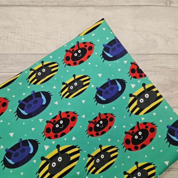 A bold circular design of ladybirds, bees and flies