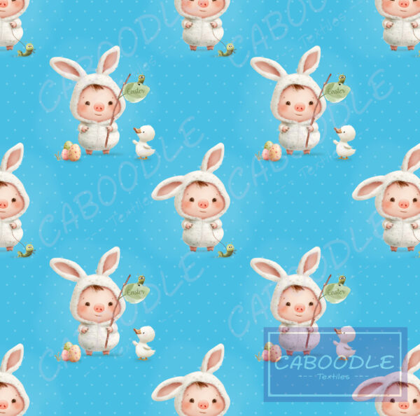 this fabric has a bright aqua background with a fancy dress bunny on an easter egg hunt